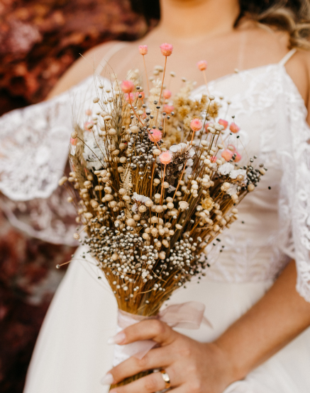 beautiful-bride-wearing-white-dress-holding-bouquet-flowers